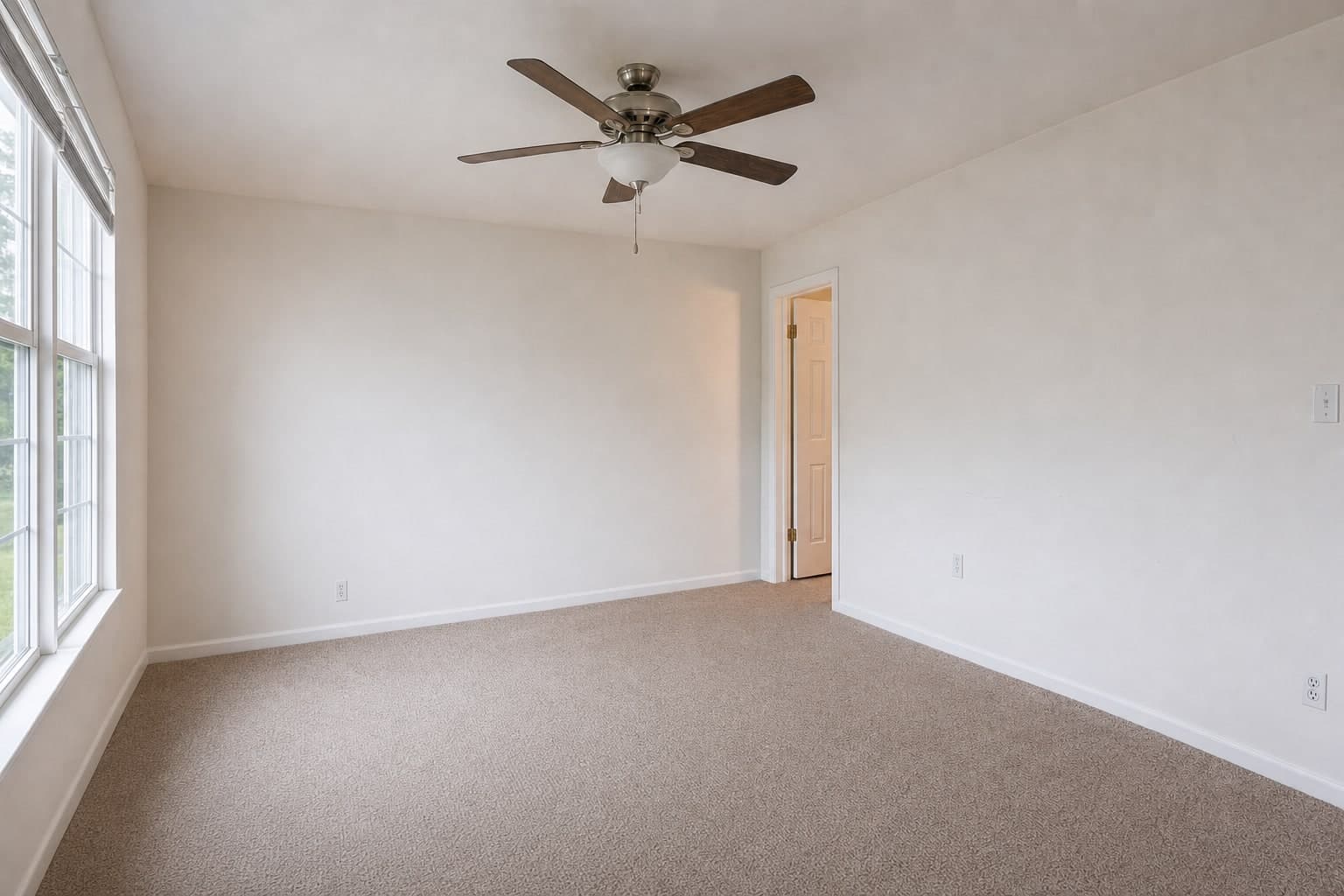 The same living room from beside the window, empty and then staged with the same furniture, as shot